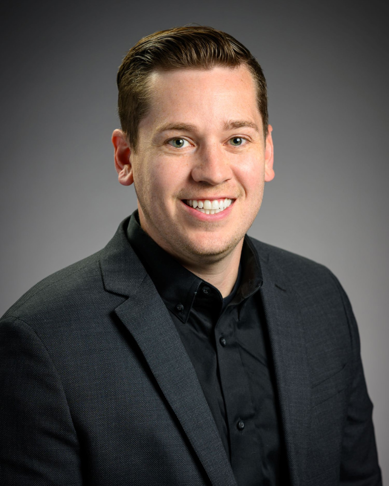 Dr. Mark Nuttall, Central Oregon dentist, smiling professionally in a dark blazer and shirt